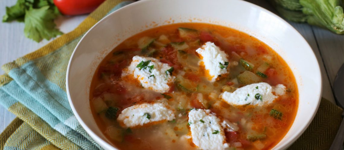 Minestra di zucchine e pomodori con quenelle di ricotta profumata alle erbe aromatiche